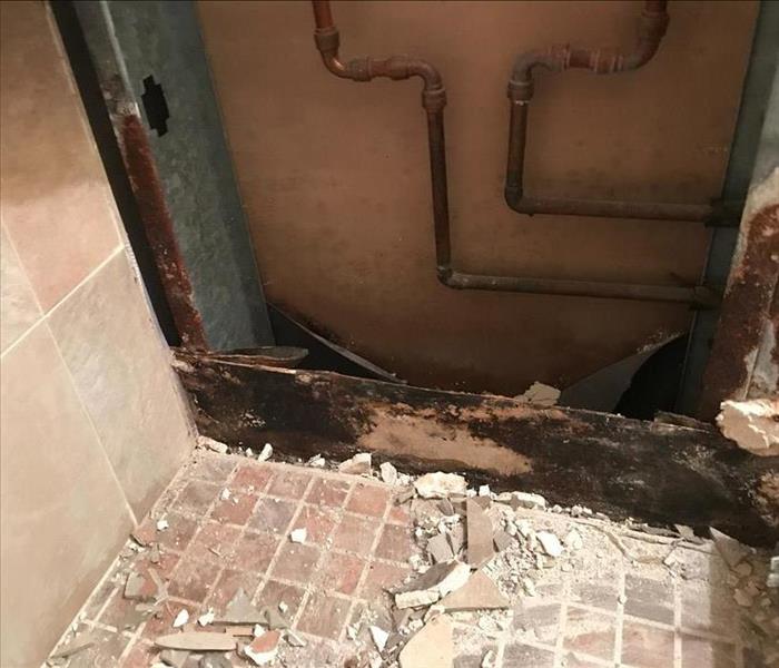 mold and water damage inside a bathroom after a storm hit Southern Florida