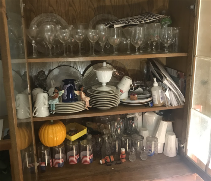 a hutch filled with glass belongings