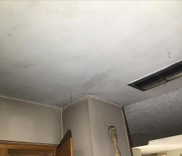 Soot damage to ceiling and wall.